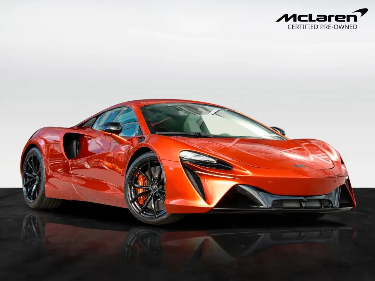 Pomarańczowy McLaren z czarnymi felgami, idealny na szybką jazdę. Sprawdź jego mclaren cena!