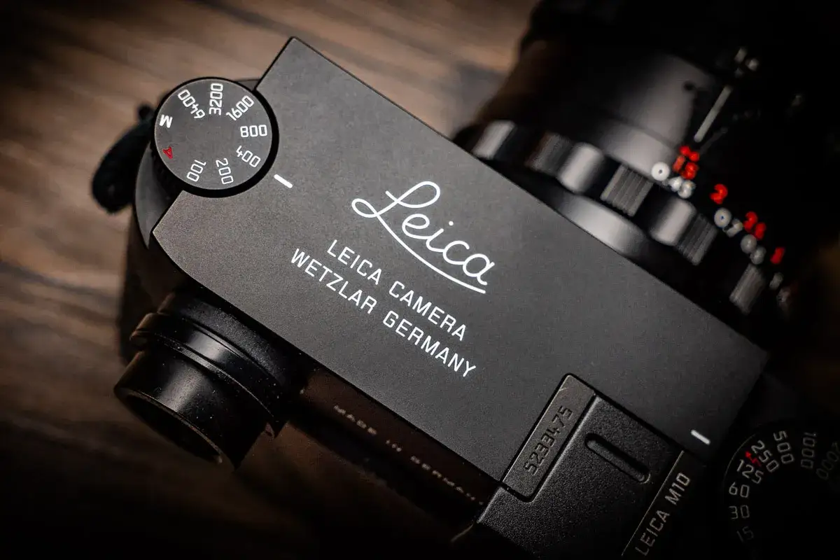 Close-up of a Leica M10 camera, showing the iconic logo and 