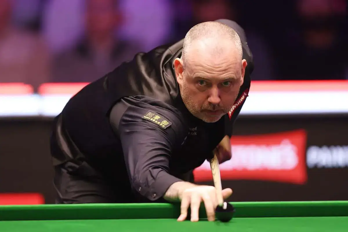 Mark Selby w skupieniu celuje do bili podczas snooker mistrzostwa świata 2025.