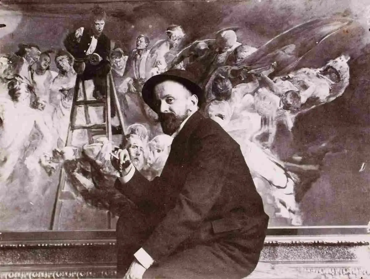 Malczewski obrazy: artysta w kapeluszu przed malowidłem z postaciami, w tym mężczyzną na drabinie.