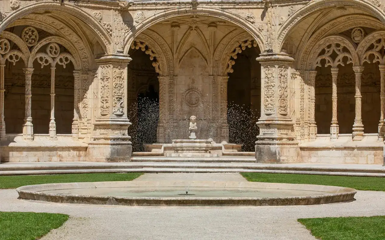 Ein Brunnen sprudelt vor der kunstvoll verzierten Fassade des Jeronimos Klosters.