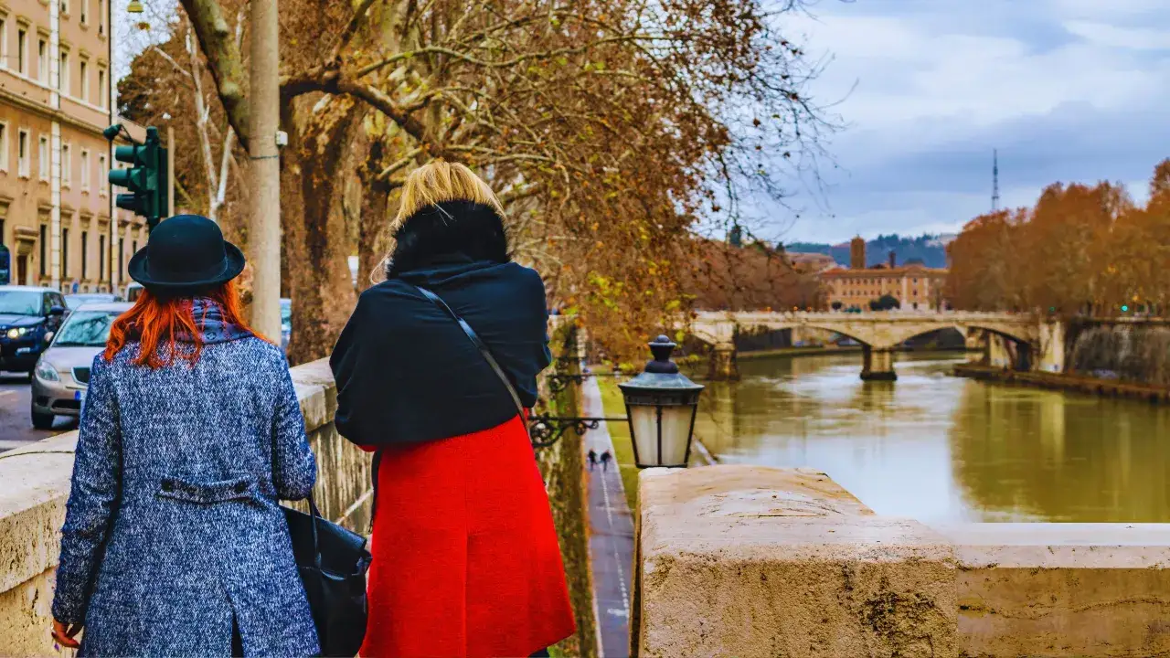 Due donne passeggiano sul lungotevere, un po' di freddo a Roma, ma la vista del fiume e dei ponti &egrave; sempre magica.