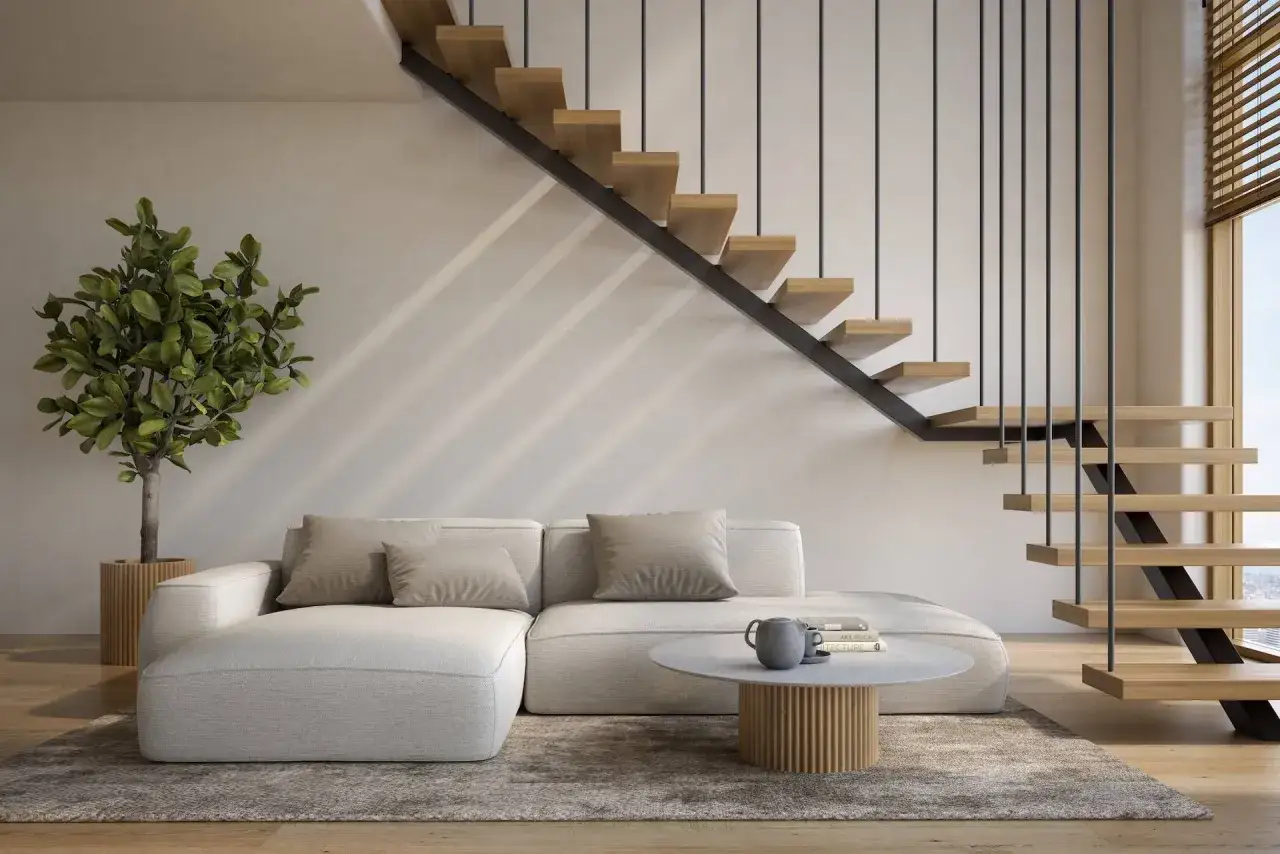 Nowoczesna antresola w domu z wygodną kanapą, stolikiem kawowym i designerskimi schodami.