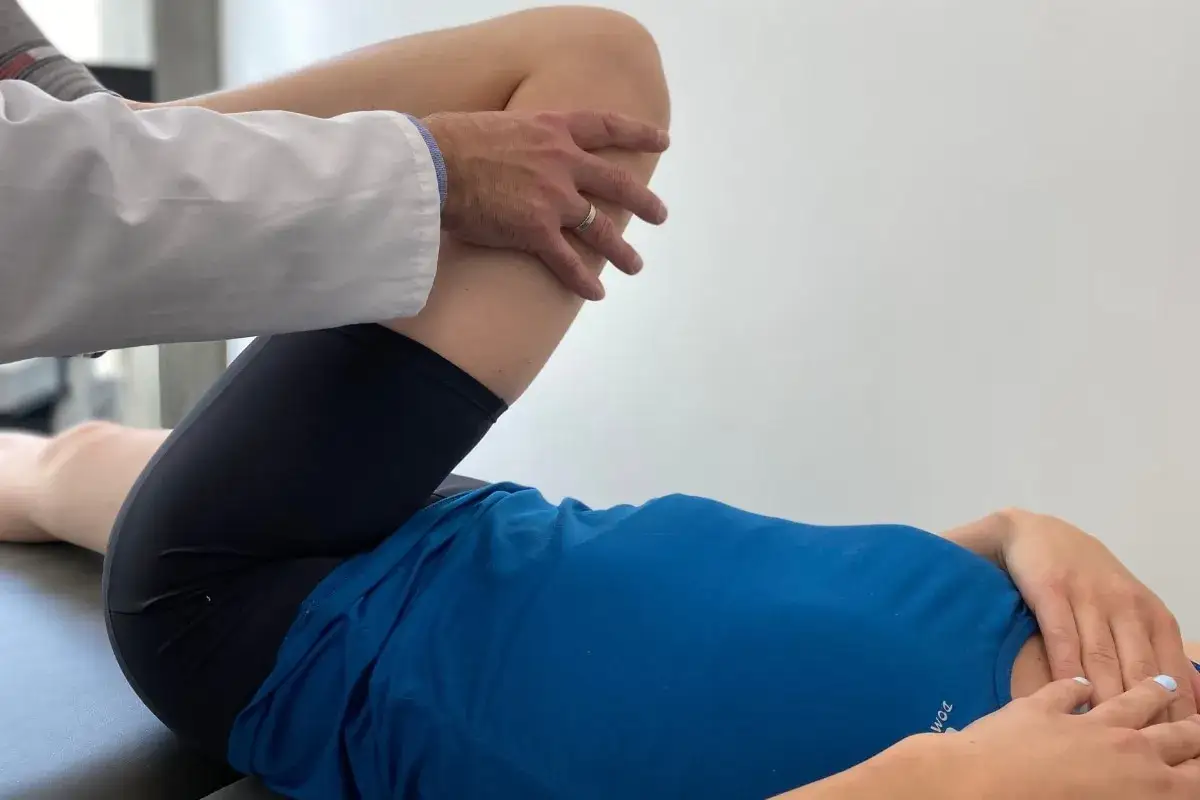 Fizjoterapeuta bada udo pacjentki, co może być częścią terapii, jak leczyć zwyrodnienie stawów.