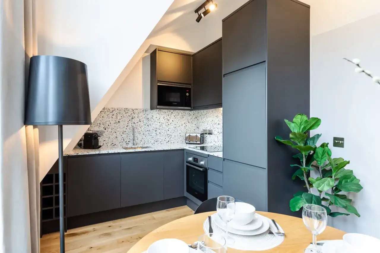 Modern grey kitchen with terrazzo backsplash. A stylish, compact space perfect for a DIY kitchen remodel, keeping the diy kitchen remodel cost in mind.