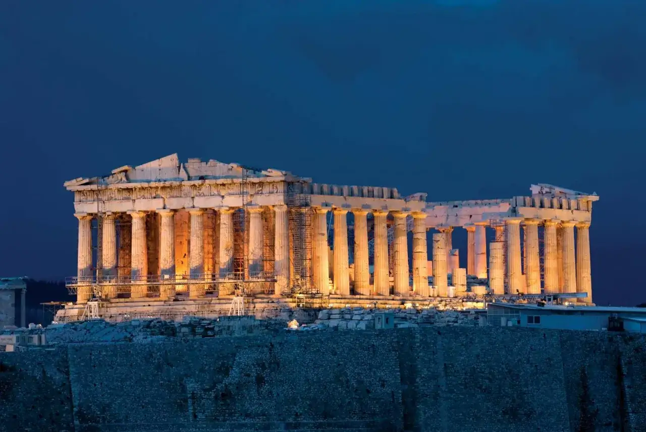 The Parthenon, a majestic temple on the Acropolis, glows under the twilight sky.