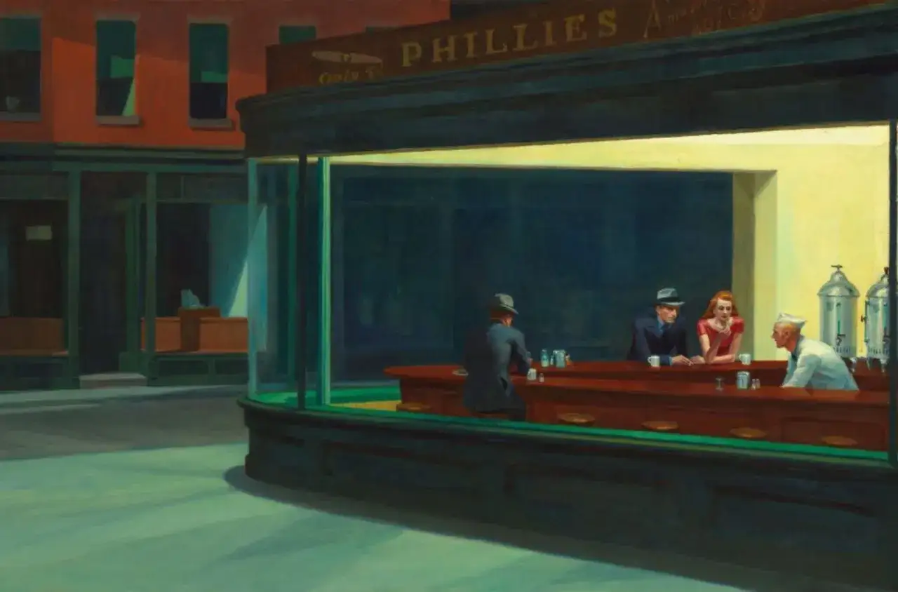 Une sc&egrave;ne nocturne typique des Edward Hopper paintings : un diner &eacute;clair&eacute;, des clients isol&eacute;s au comptoir, une atmosph&egrave;re m&eacute;lancolique.