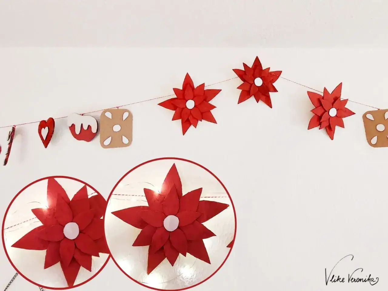 Rote Papier-Weihnachtsstern-Girlande mit Lichtern. Ein weihnachtsstern dunkel stellen, um die Lichter hervorzuheben.