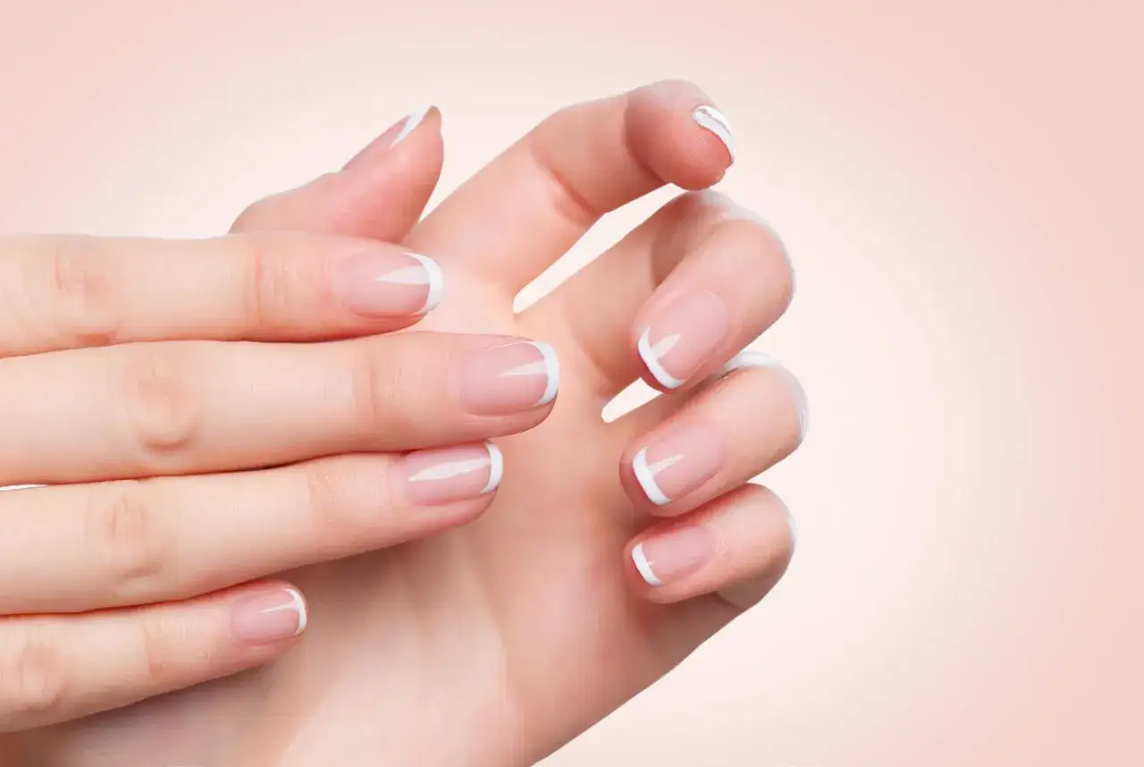 Dłonie z idealnym french manicure. Chcesz wiedzieć, co zrobić, żeby paznokcie szybciej rosły?