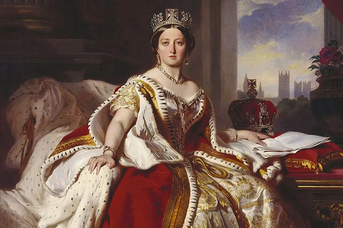 Retrato de la reina Victoria de Inglaterra, luciendo su corona y manto real, con el parlamento brit&aacute;nico al fondo.
