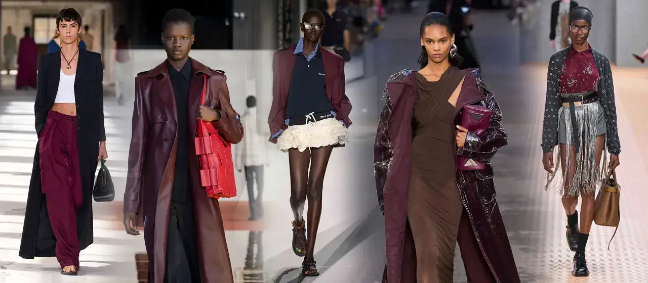 Modelli sfilano con abiti eleganti, tra cui un trench in pelle bordeaux e pantaloni abbinati. L'abbinamento bordeaux domina la passerella.