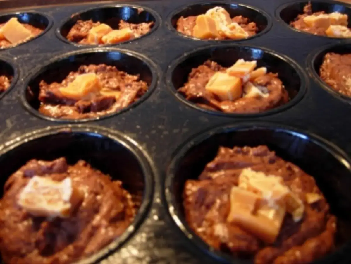 Schokoladen-Muffins mit Karamellstücken, bereit zum Backen. Diese Snickers Muffins duften schon jetzt himmlisch!