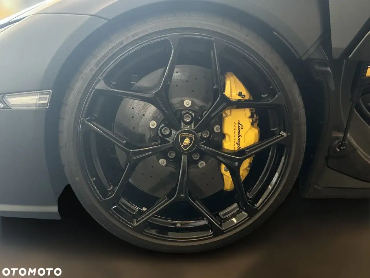 Koło Lamborghini z żółtymi zaciskami hamulcowymi. Zastanawiasz się, ile kosztuje lamborghini?