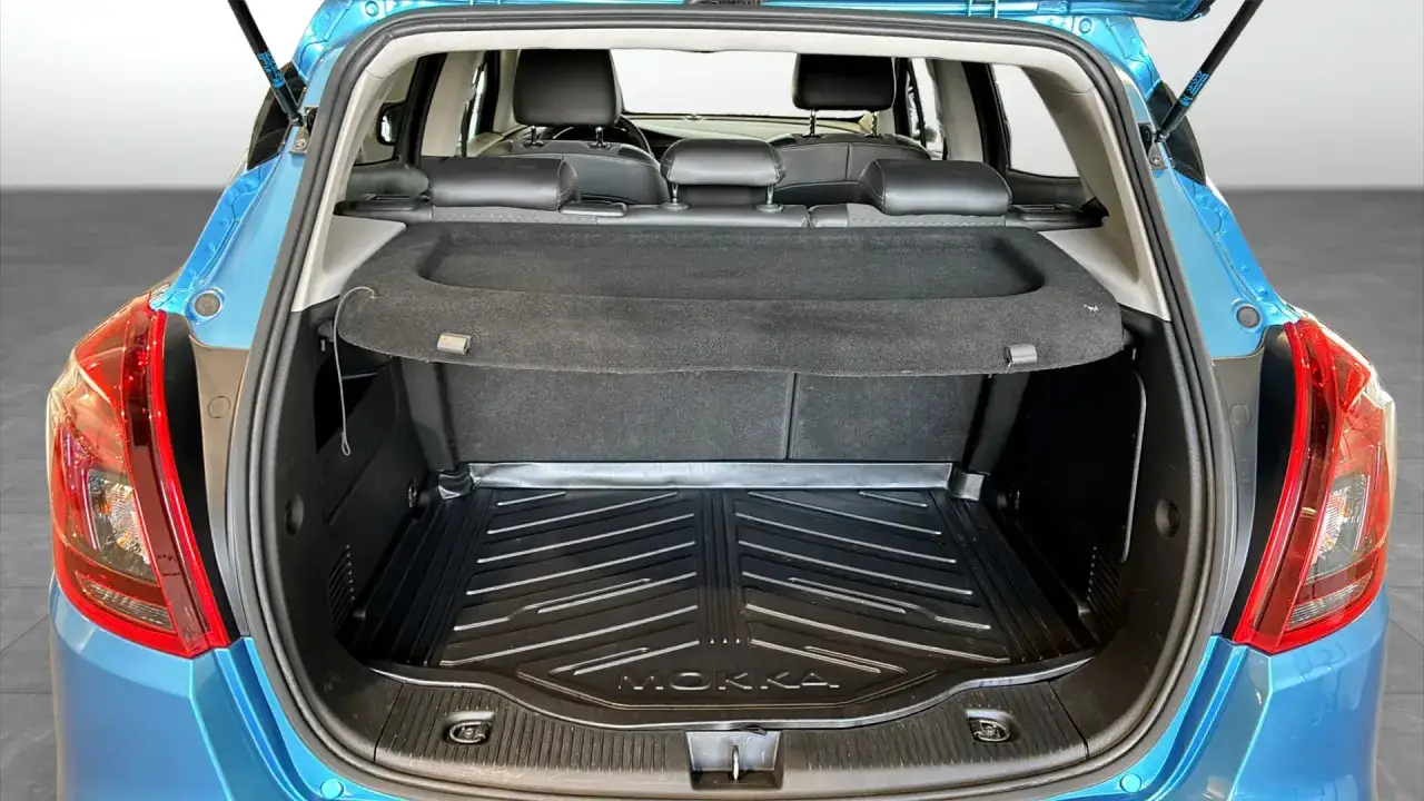 Bagageutrymmet i en bl&aring; Opel Mokka. Perfekt f&ouml;r en begagnad bil, redo f&ouml;r ett nytt &auml;ventyr.