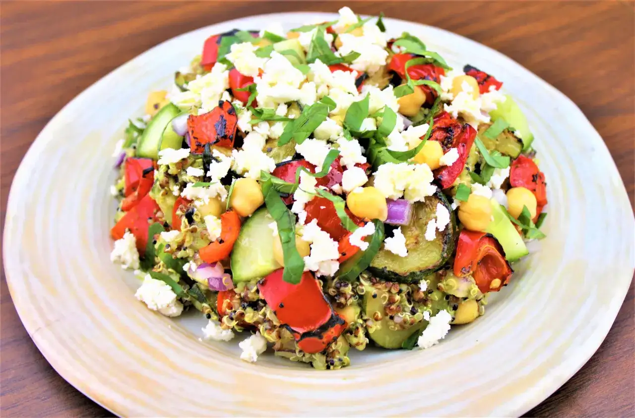 En h&auml;rlig quinoa sallad med grillade gr&ouml;nsaker, kik&auml;rtor, gurka, r&ouml;dl&ouml;k och smulad fetaost.