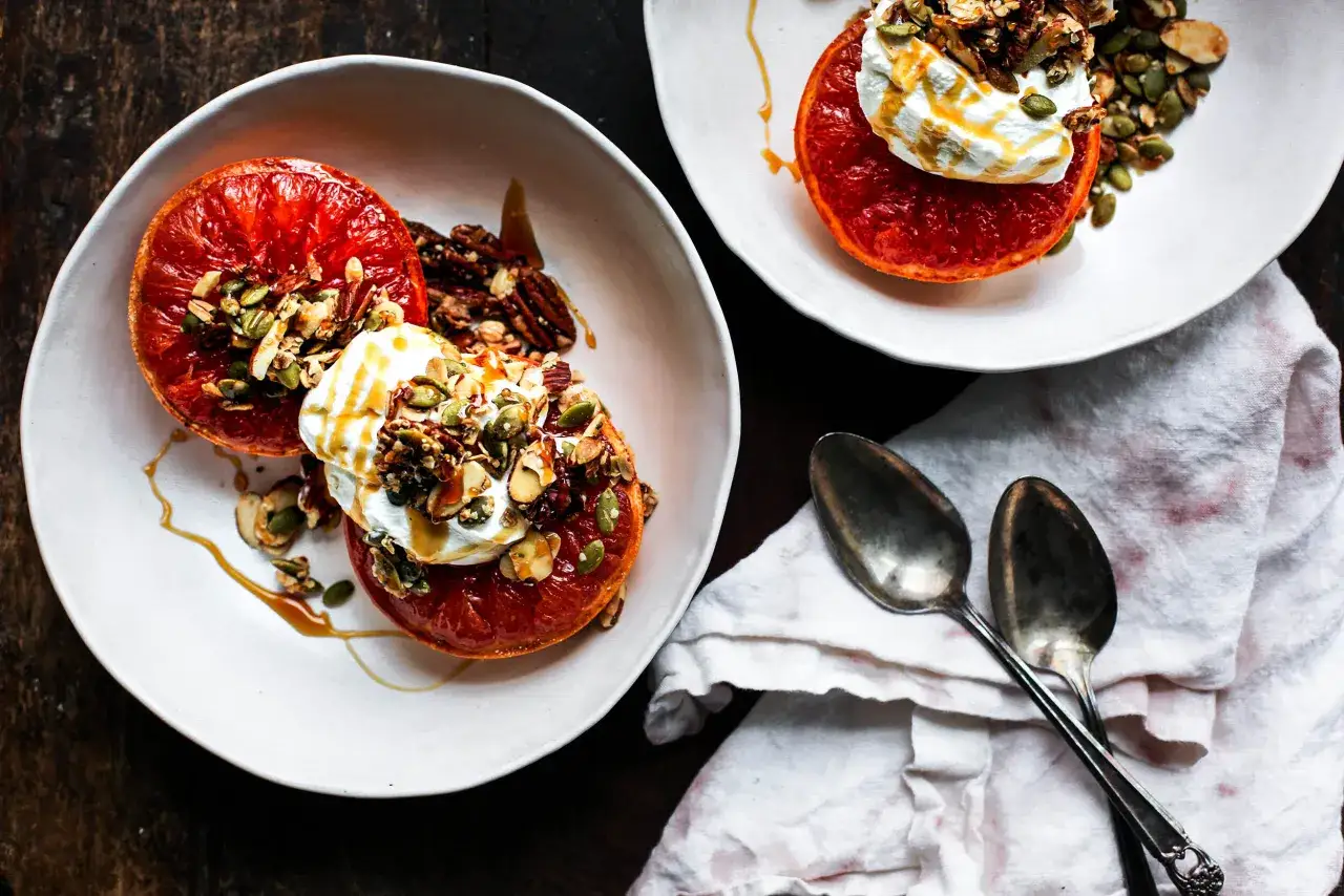 Pompelmi grigliati con yogurt, granola e miele, un'idea leggera per mangiare pompelmo la sera.