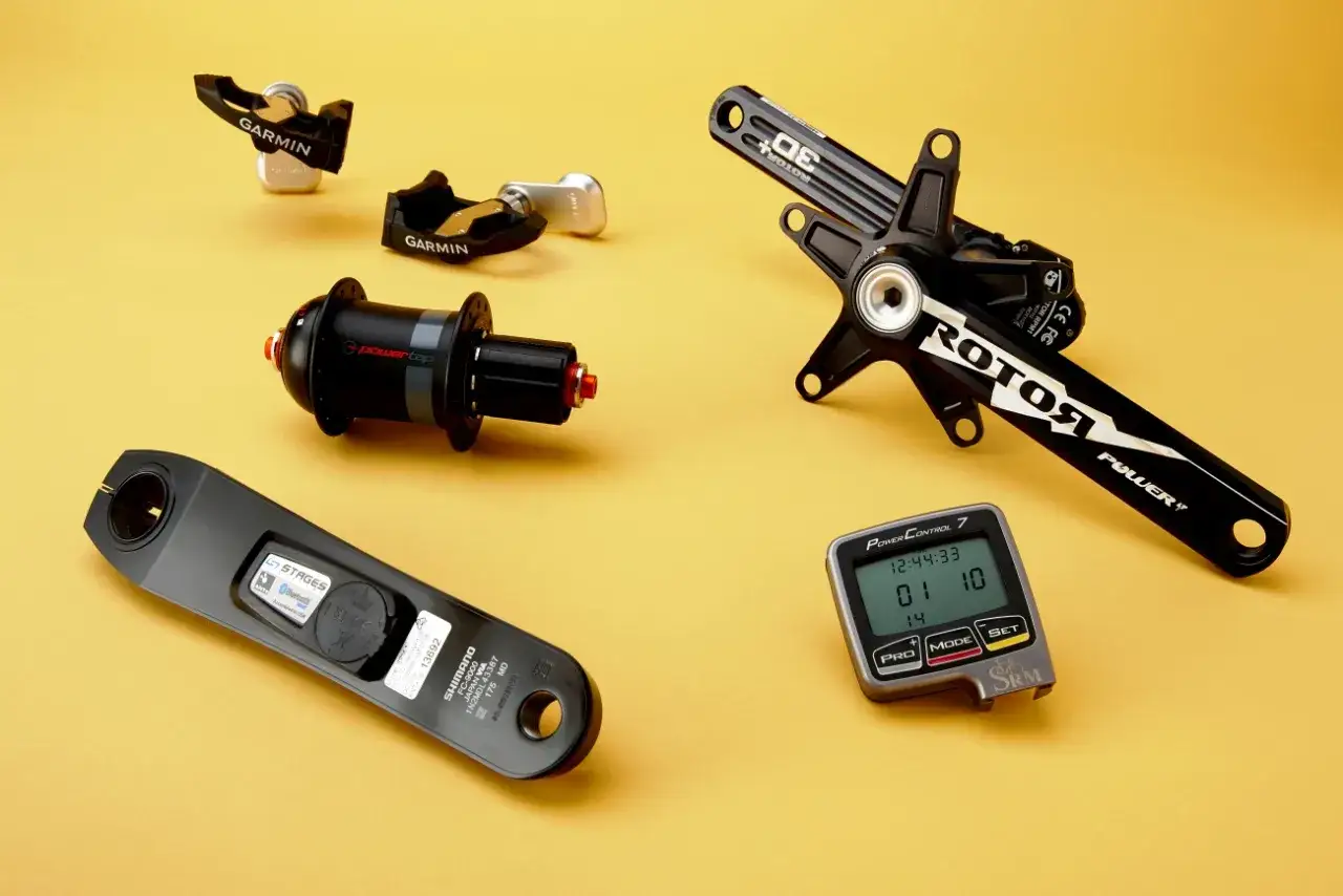 Various cycling power meters and a head unit, ready to measure your cycling watts.