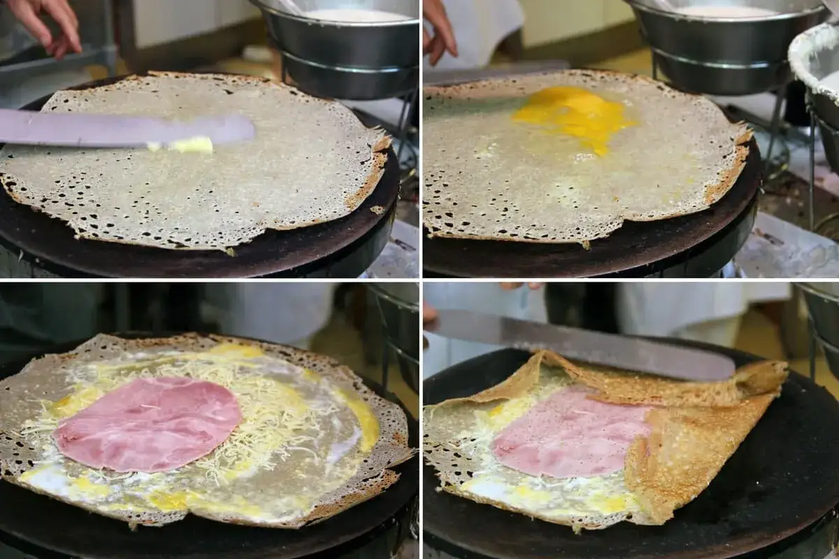 Préparation d'une galette de sarrasin : on y ajoute du beurre, un œuf, du fromage râpé et une tranche de jambon avant de la plier.