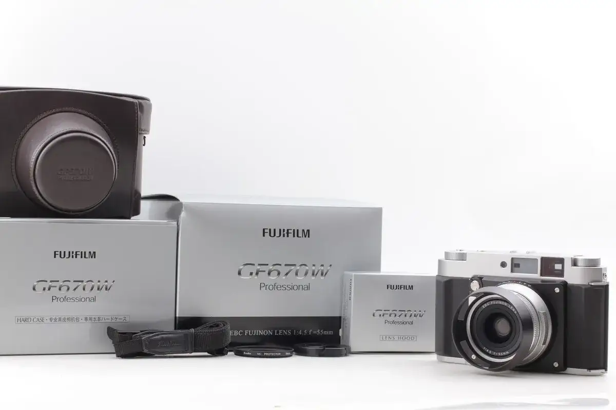 The Fujifilm GF670W Professional camera, its case, boxes, lens hood, and strap are displayed.