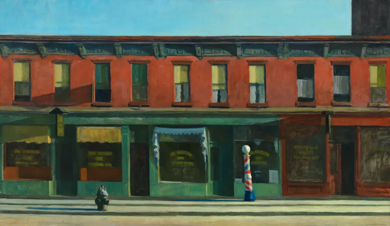 Edward Hopper namalował fasadę kamienicy z czerwonej cegły, zielonymi witrynami sklepów i słupem cyrulika.