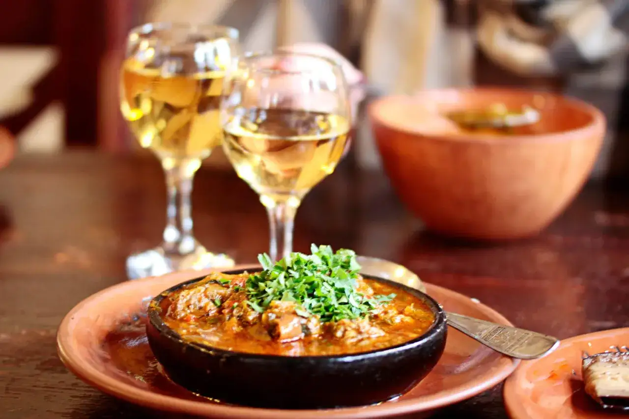 Un plat de chili con carne épicé, garni de persil frais, servi avec deux verres de vin blanc. Quel vin blanc avec chili con carne ?