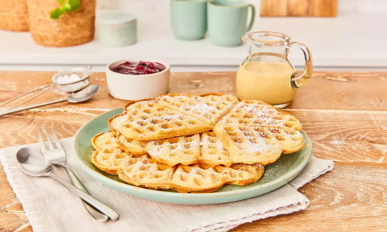 Herzhafte waffeln ohne ei, best&auml;ubt mit Puderzucker, serviert mit Marmelade und Vanillesauce. Ein Genuss f&uuml;r jeden Tag!