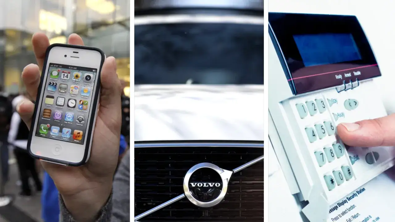 En hand håller en iPhone med Telia 3G-signal, en Volvo-grill och ett larmtangentbord.