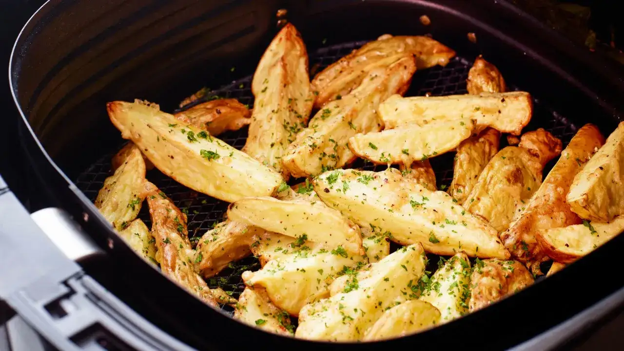 Gylla klyftpotatis i airfryer, strödd med färsk persilja. Perfekt som tillbehör eller snacks.