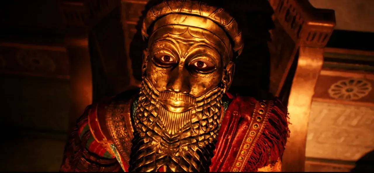 M&aacute;scara dorada de un antiguo rey, con barba de escamas y vestimenta ceremonial, como si emergiera de la casa de cenizas.