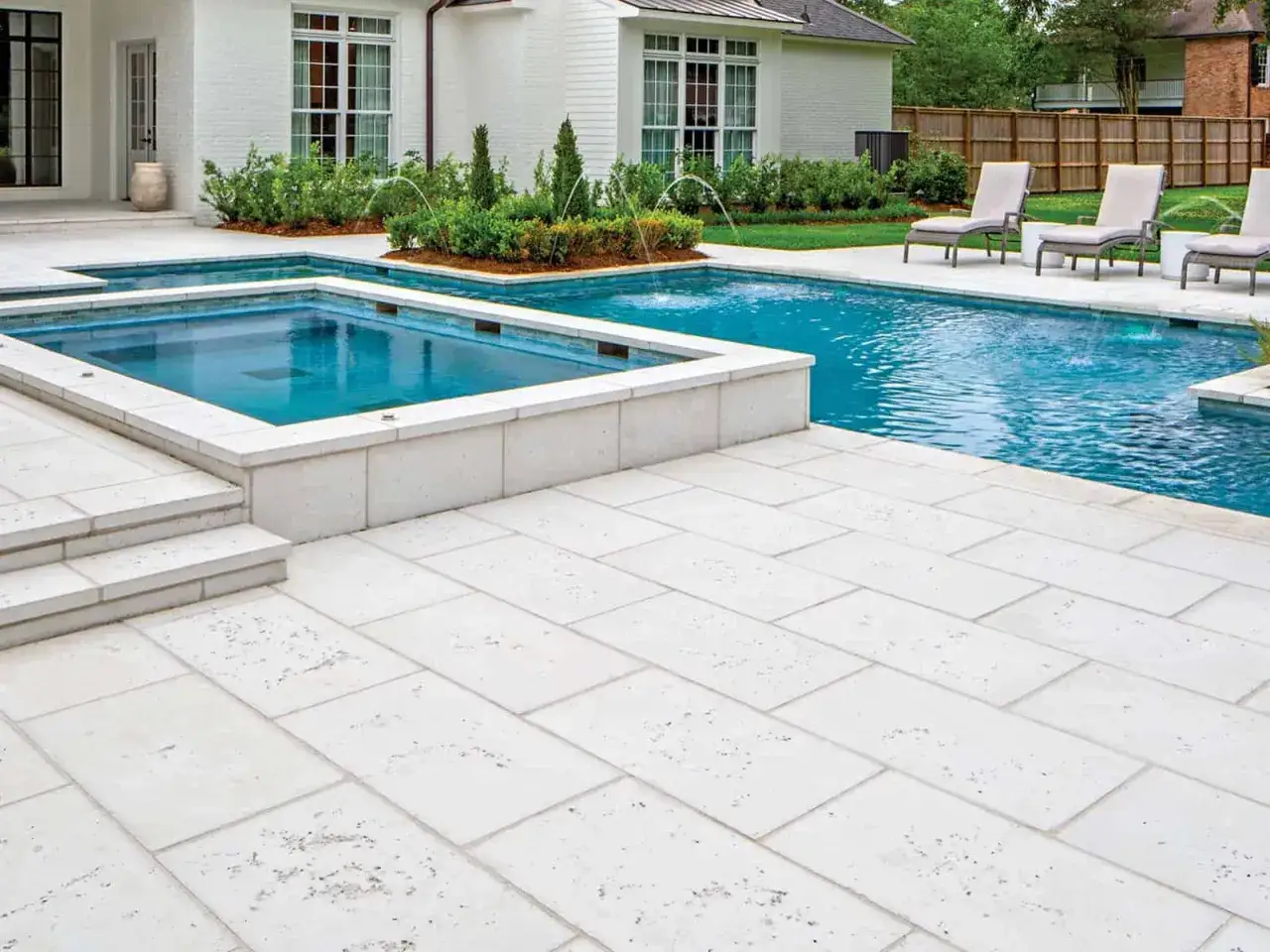 Amplia terraza con piscina y jacuzzi, pavimentada con suelos para piscinas que no quemen, ideales para disfrutar del verano sin preocupaciones.
