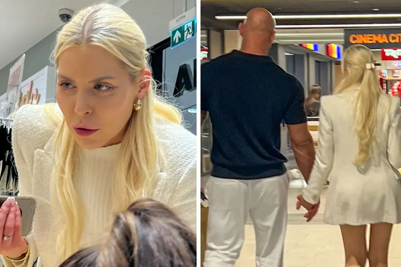 Julia von Stein w białej marynarce i jej partner, którego wzrost jest znaczący, idą trzymając się za ręce.