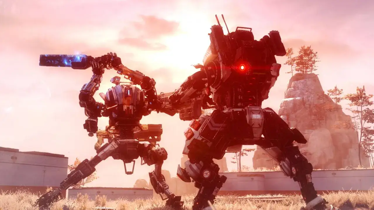Dwa tytany walczą na tle zachodzącego słońca. Jeden z nich trzyma broń z niebieskim promieniem. Wygląda jak scena z **Titanfall 3**.