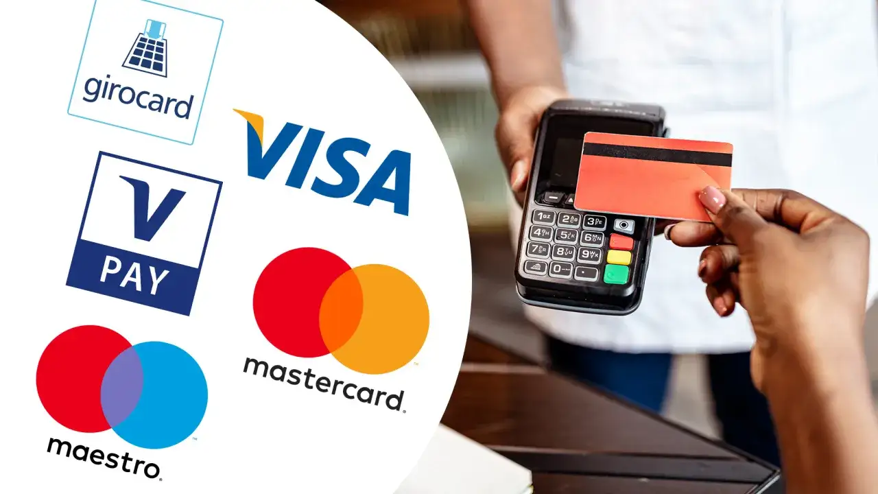 Zahlung mit Girocard, Visa, Mastercard, Maestro oder V-Pay. Eine Hand h&auml;lt eine rote EC-Karte an ein Terminal.