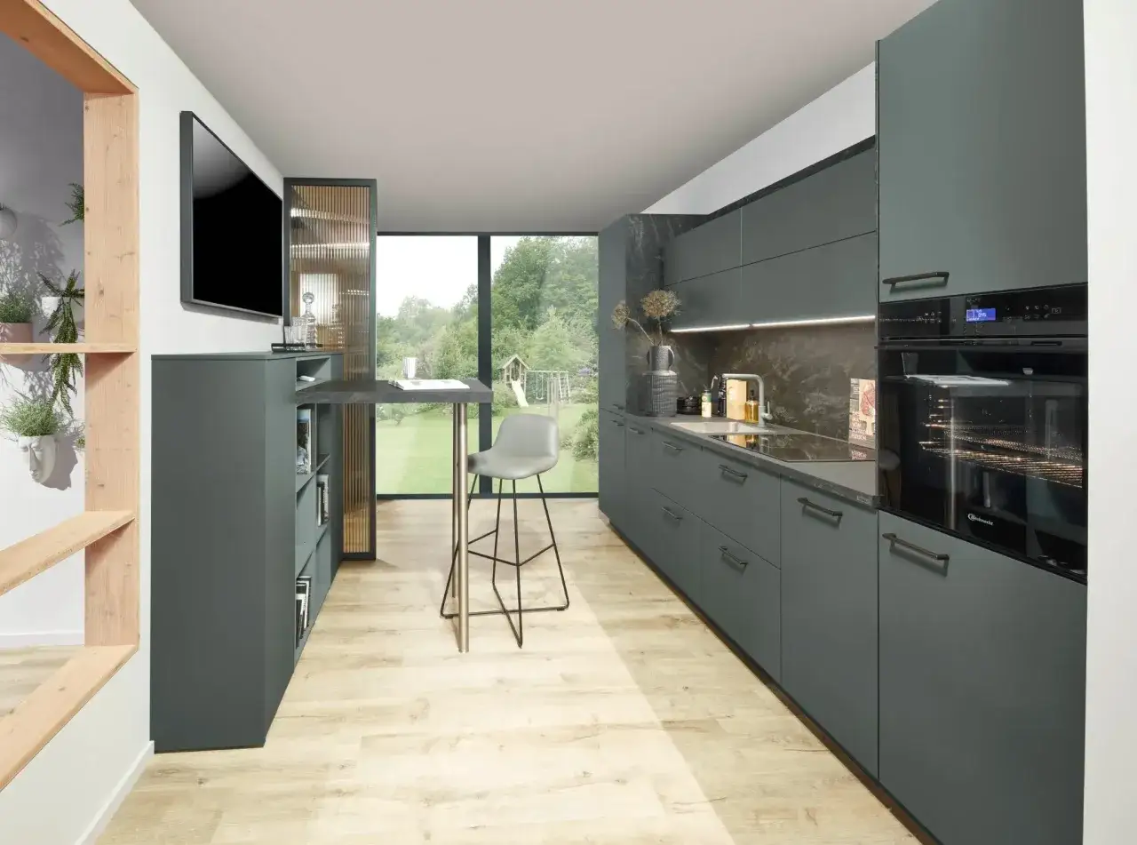 Elegante cocina con gabinetes verde gris&aacute;ceo y encimera de piedra oscura. La combinacion colores para cocina crea un ambiente moderno y acogedor.