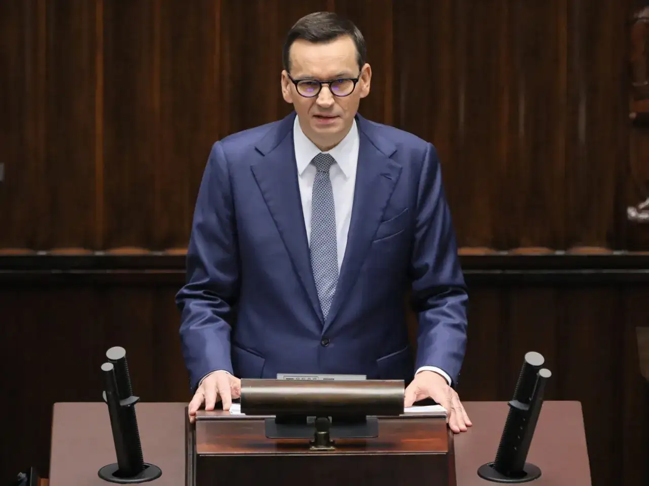 Mateusz Morawiecki w garniturze i krawacie przemawia, by expose rządu.