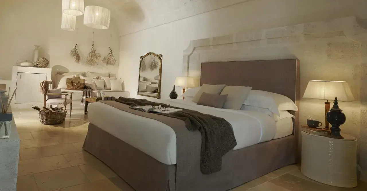 Cozy king bed styled with a textured throw, book, and glasses. Learn how to style king bed for a relaxing retreat.