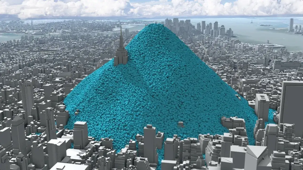 Ein riesiger blauer Berg aus Kugeln, der eine Stadt &uuml;berragt, veranschaulicht, was eine Tonne CO2 ist.