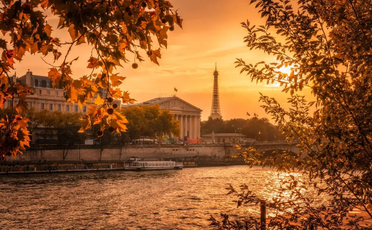 Atardecer dorado sobre el Sena, con la Torre Eiffel y edificios históricos. Ideal para planificar qué ver en París en 2 días.