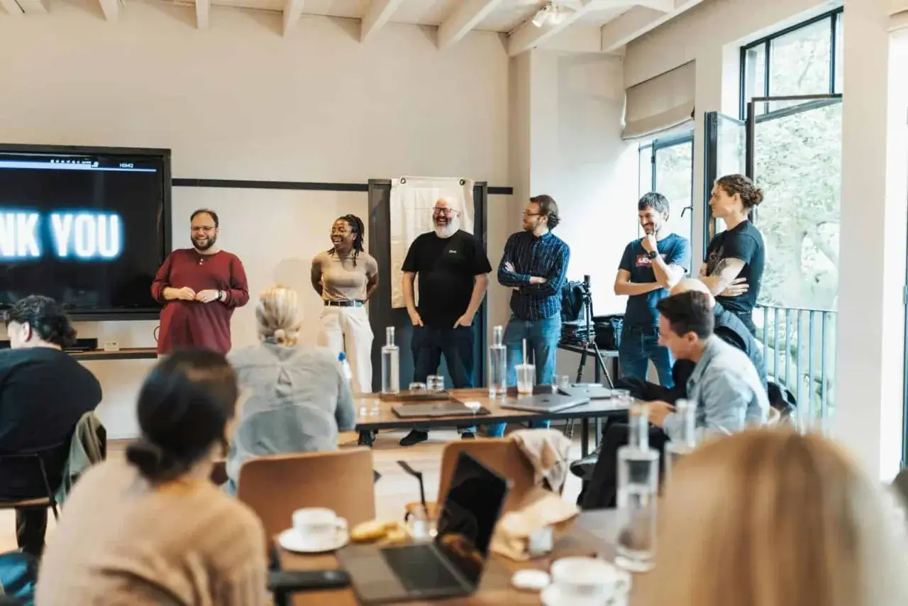 A group of people attend a presentation, possibly celebrating the completion of a business leadership certificate program.