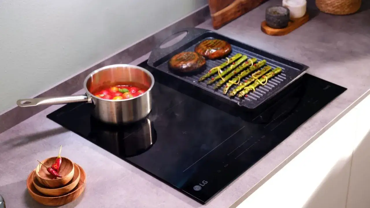 Un piano a induzione LG prepara una cena deliziosa: asparagi grigliati e sugo di pomodoro. Scopri quanto consuma un piano a induzione per pasti efficienti.