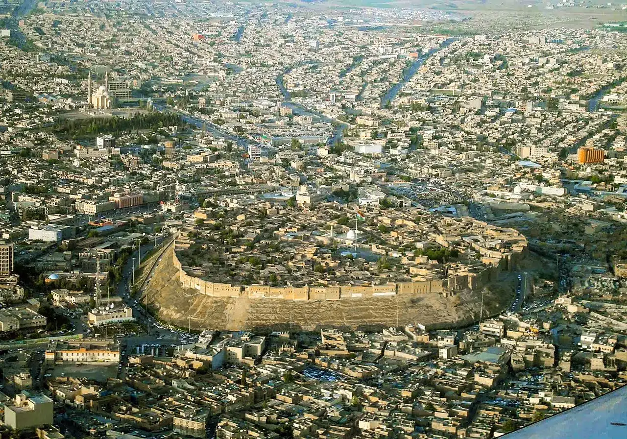 Luftaufnahme der Zitadelle von Kirkuk im Irak, umgeben von einer weitl&auml;ufigen Stadt.