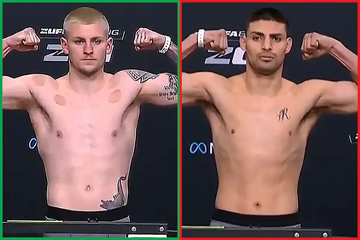 Two fighters pose during a weigh-in for a boxing match. The fighter on the left has blonde hair and cupping marks on his shoulders. The fighter on the right has dark hair and a tattoo on his chest.
