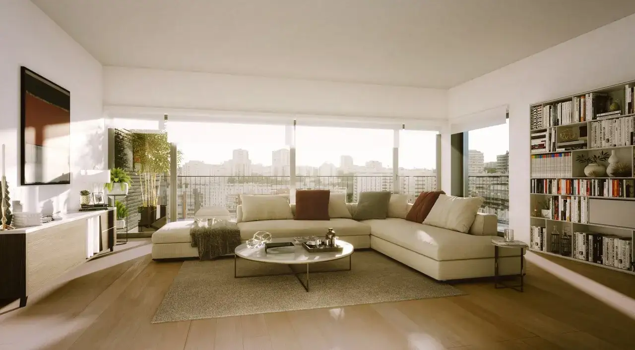 Un salón moderno y luminoso, ideal para inspirarte a diseña tu salón. Sofá modular beige, mesa de centro redonda y estantería llena de libros.