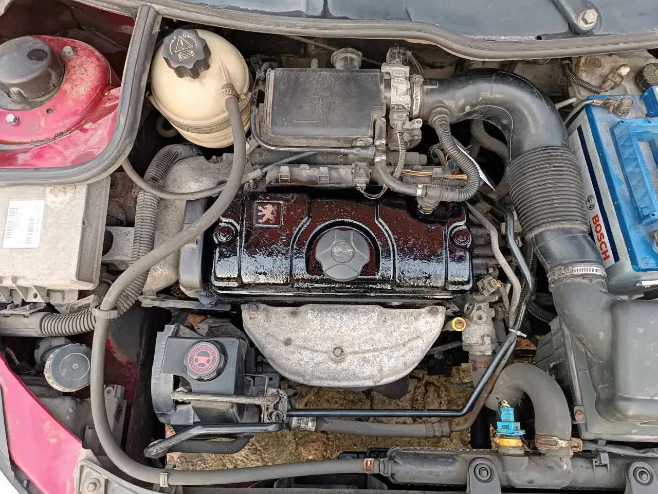 Silnik Peugeot 206 S16, widok z góry. Błyszcząca czarna pokrywa zaworów z logo Peugeot.