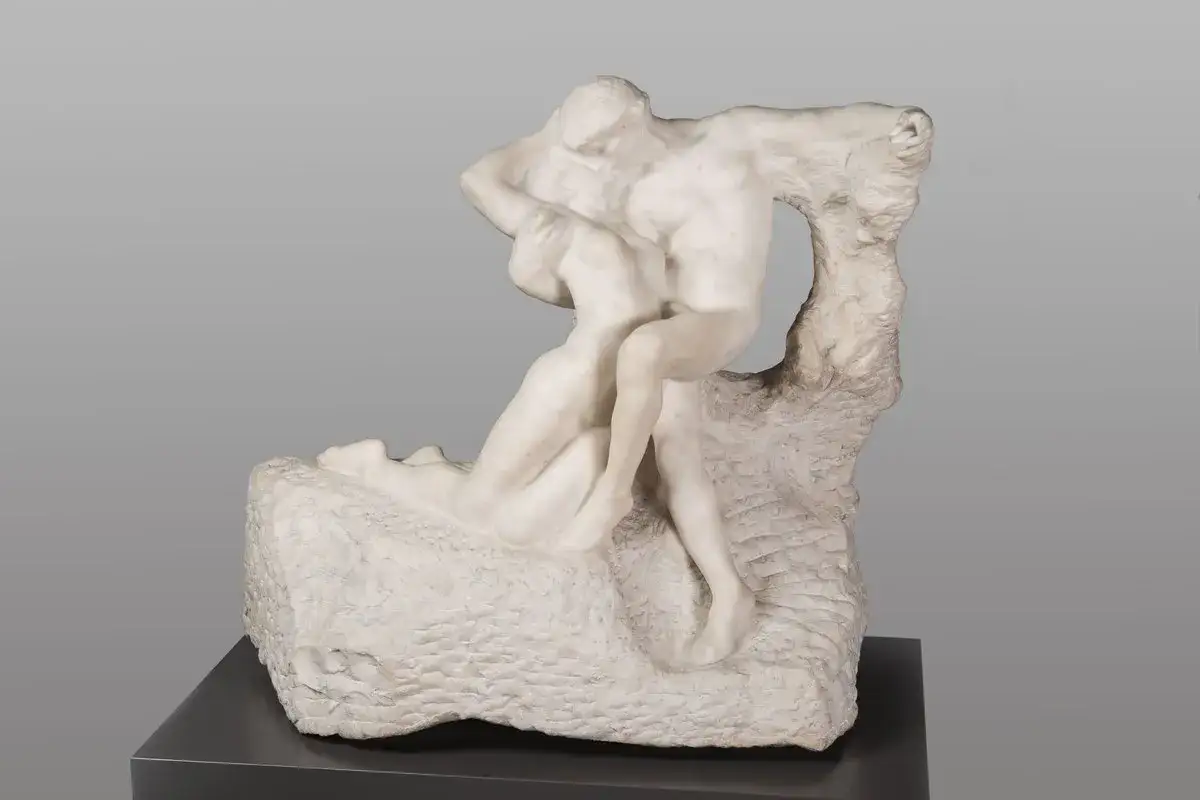 A marble sculpture of two embracing figures, capturing the passion of Rodin's Eternal Spring.