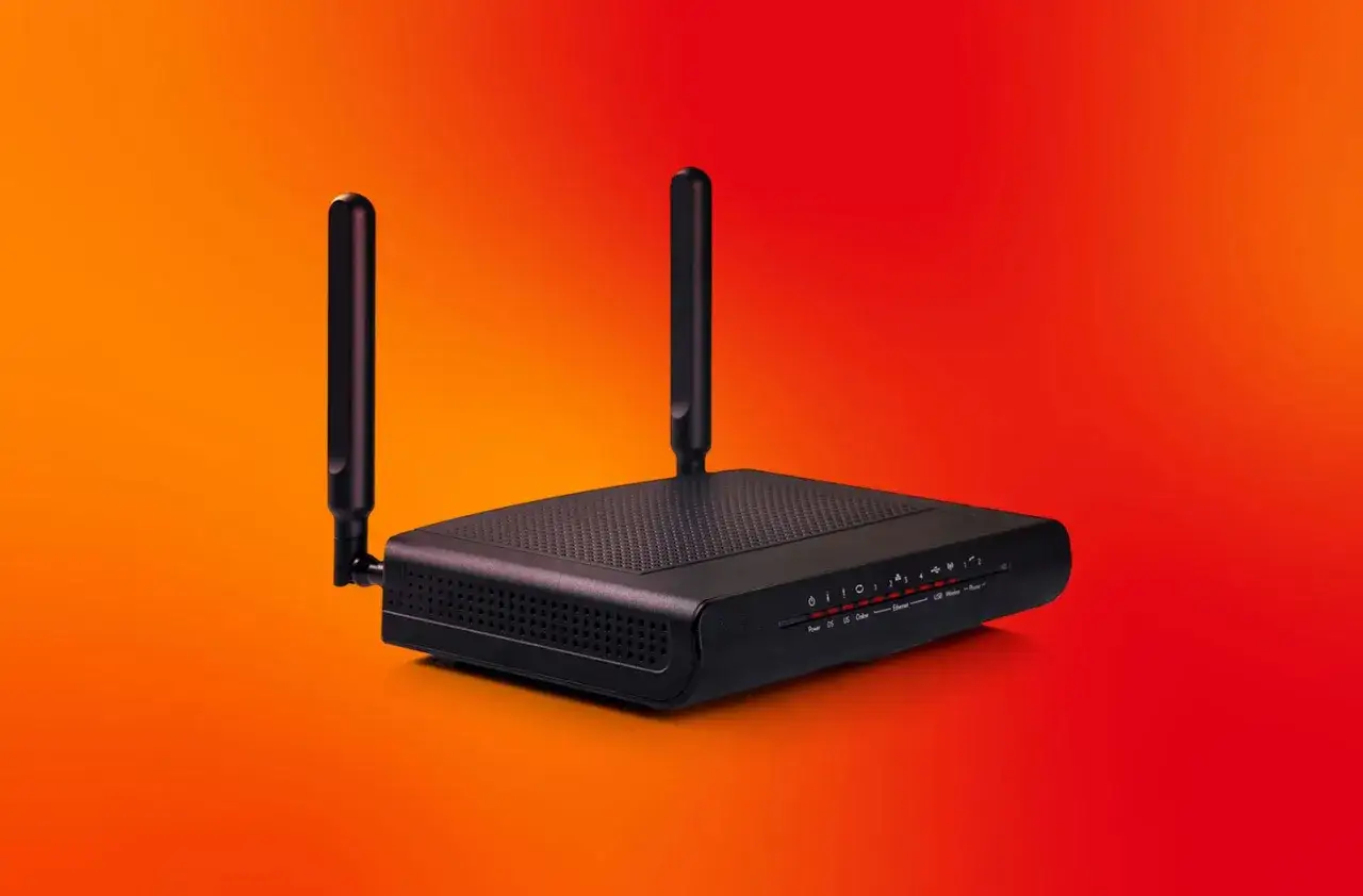Schwarzer WLAN-Router mit Antennen auf orange-rotem Hintergrund. Die Lichter zeigen den Status an, was die Bedeutung von