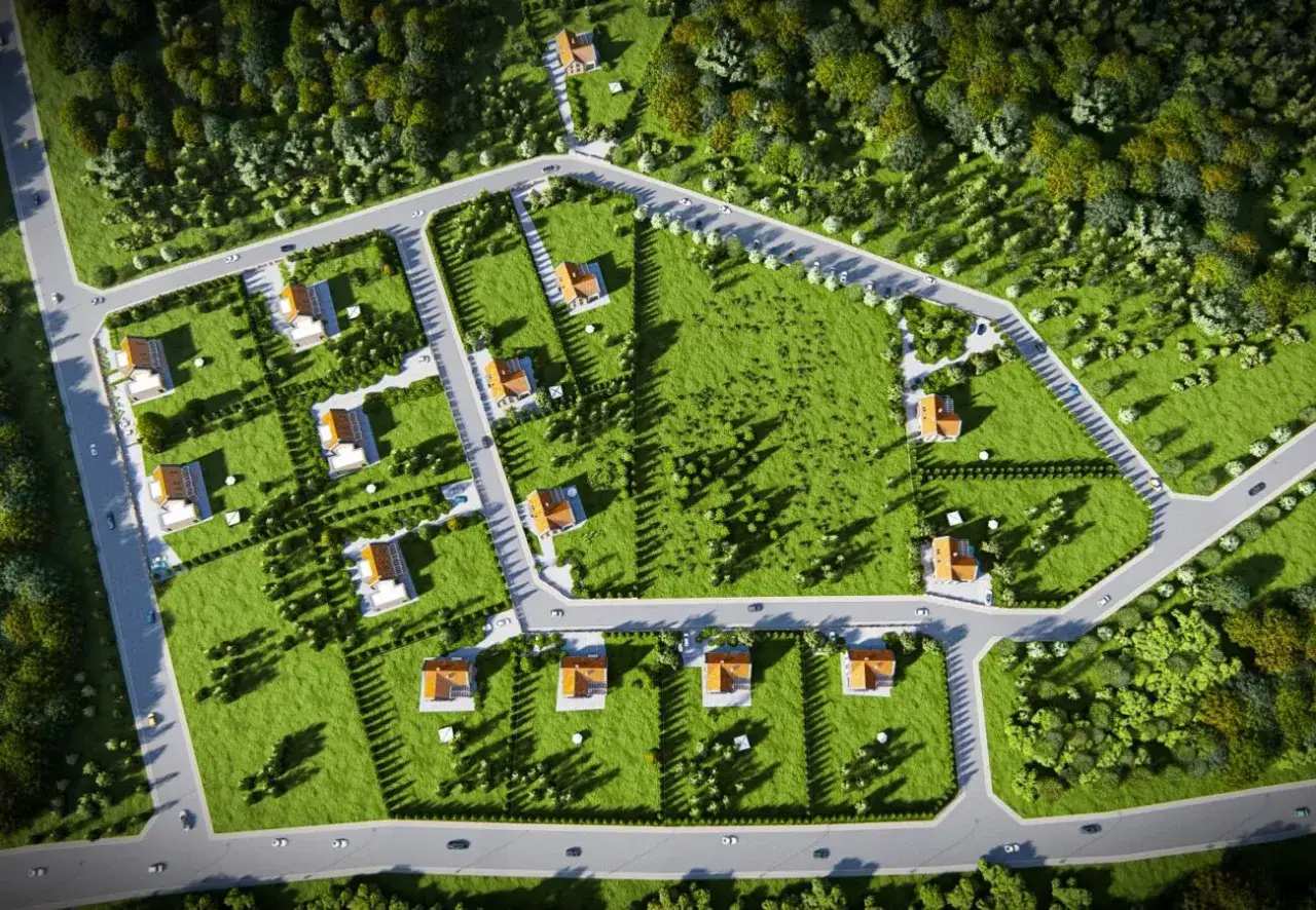Jak narysować plan osiedla? Widok z lotu ptaka na nowe domy z ogrodami, drogi i zieleń.