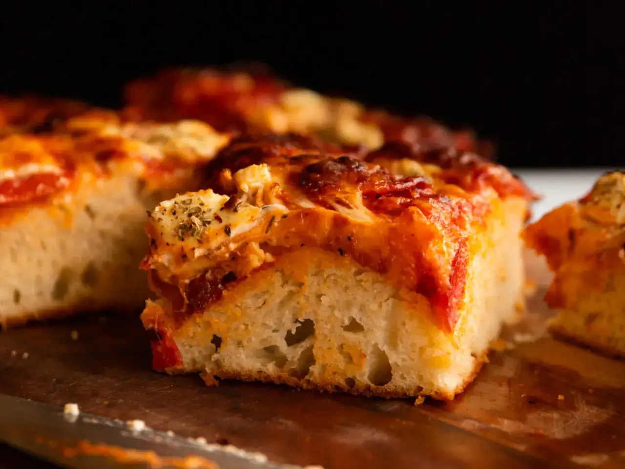 Tranches de pizza g&eacute;n&eacute;reuses, garnies de sauce tomate et de fromage fondant, pr&ecirc;tes &agrave; &ecirc;tre d&eacute;gust&eacute;es.