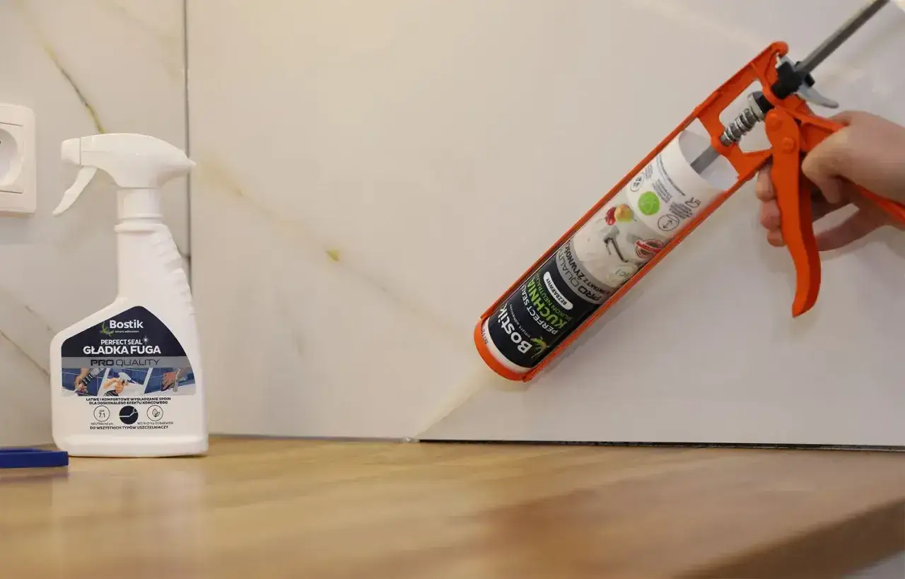 Aplikacja silikonu do blatu kuchennego. Pistolet z tubą silikonu Bostik Perfect Seal Kuchnia neutralny bezbarwny uszczelnia szczelinę.
