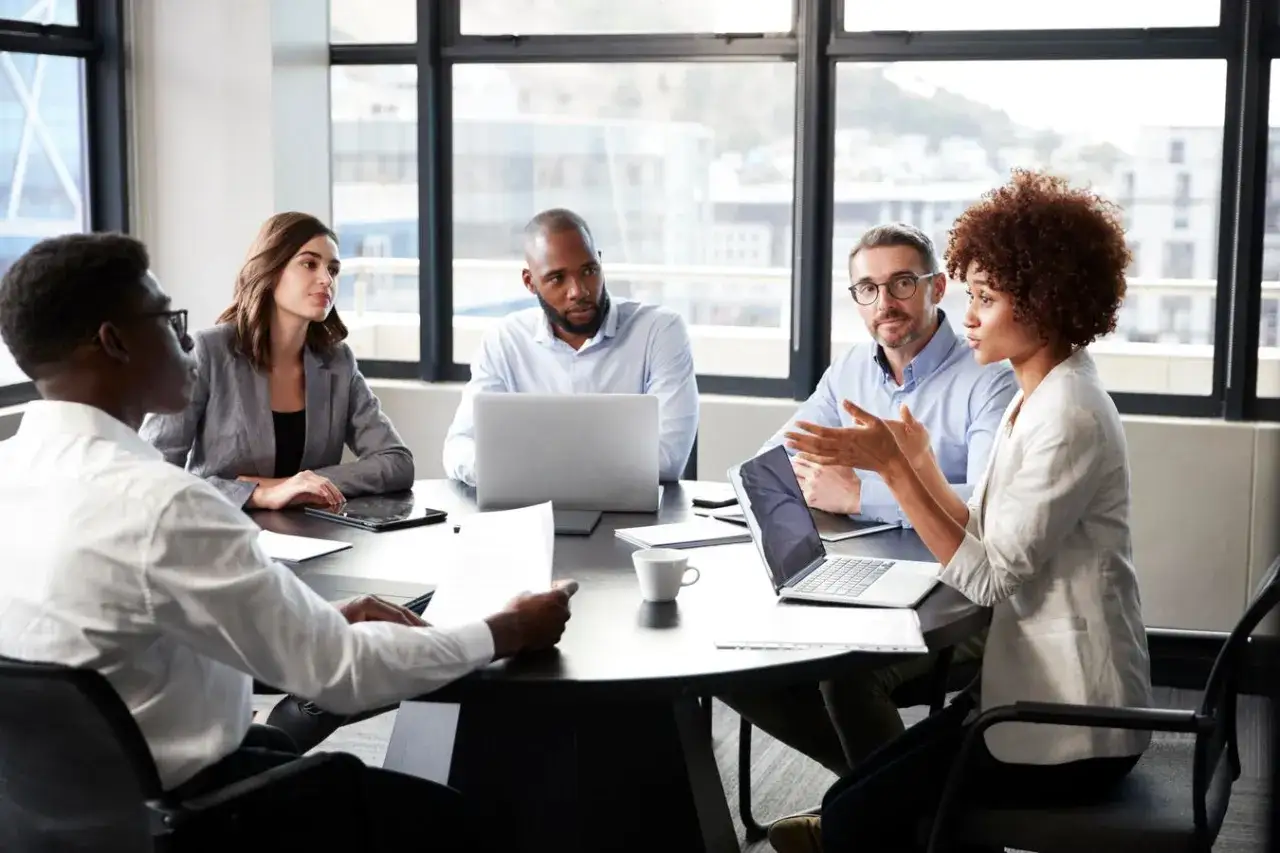 A diverse team discusses strategy, highlighting why emotional intelligence is important in leadership for effective collaboration and understanding.